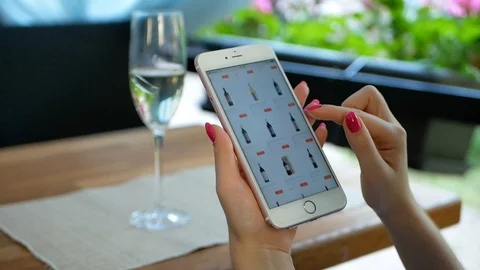 Close up of beautiful young woman's hands holding mobile smart phone sitting in Stock Footage 100757864