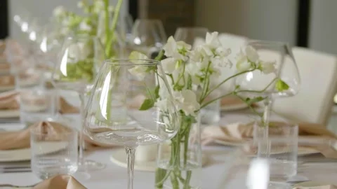 Close-up of a beautifully set dining table with floral centerpieces and candles. Stock-Footage 288105036