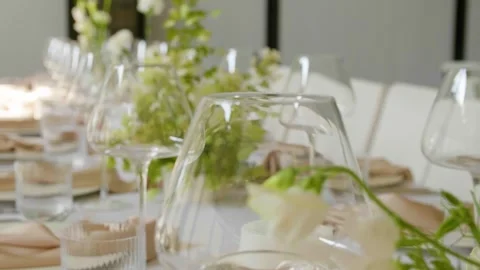 Close-up of a beautifully set dining table with floral centerpieces and candles. Stock-Footage 288105151