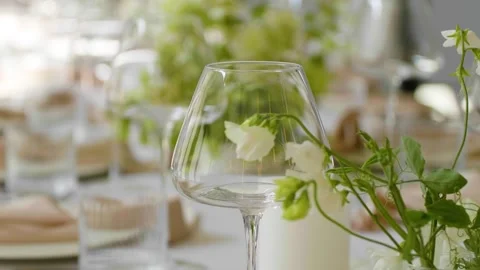 Close-up of a beautifully set dining table with floral centerpieces and candles. Stock-Footage 288105578