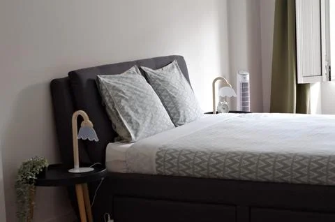 Close up bed with grey pillows. Interior room with bed Stock Photos