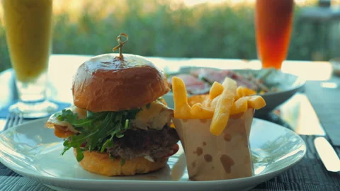 Close-up of beef burger on restaurant table with bacon and cheese Stock Footage 233068225