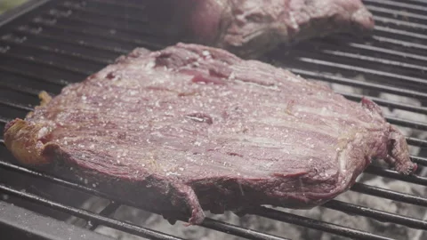  Close up on beef in the heat of the grill, ashes flying Stock Footage 138540138
