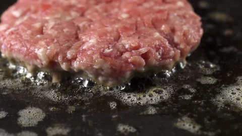 Close-up of beef meat for a burger is fried in a hot pan 스톡 동영상 105031729