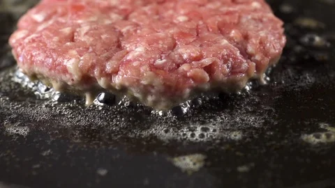 Close-up of beef meat for a burger is fried in a hot pan 스톡 동영상 105031743