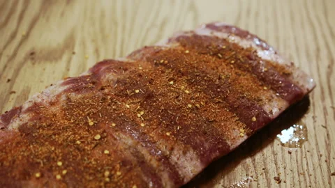 Close up of beef ribs are being greased with herbs and spices on the kitchen. Stock Footage 86738418