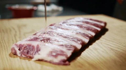 Close up of beef ribs being prepared for the cooking in expensive restaurant Stock Footage 88573254