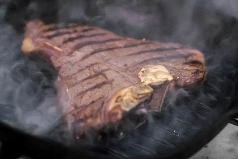 Close up beef steak roasted on grill pan Stock Photos