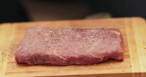 Close-up of a beef steak on a wooden board Stock Footage 258647243