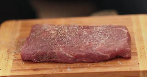 Close-up of a beef steak on a wooden board Stock Footage 258647880