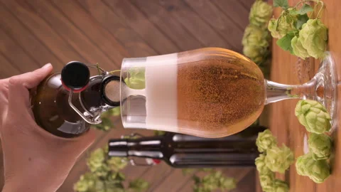 Close-up of beer being poured from a brown bottle into a transparent glass. Rich 스톡 동영상 311817424