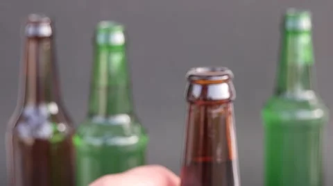 Close up of beer bottle in a man's hands Stock Footage 68768884