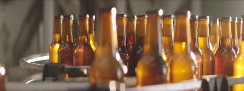 Close-up of beer bottles on a conveyor Stock Footage 147357305