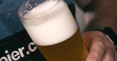 Close up of beer filling clear glass in industrial brewery factory line Stock Footage 335141853