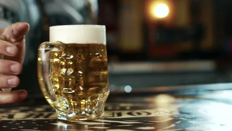 Close up of beer mug is being delivered to the client in stylish bar. Stock Footage 87323761