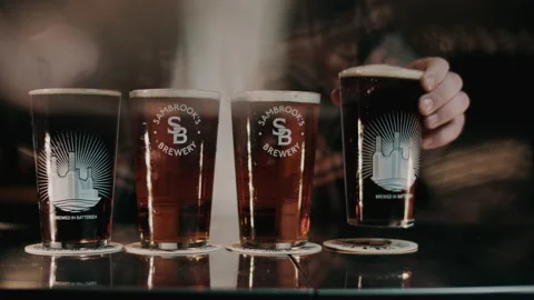 Close up of beers being placed on the bar counter Stock Footage 132012210
