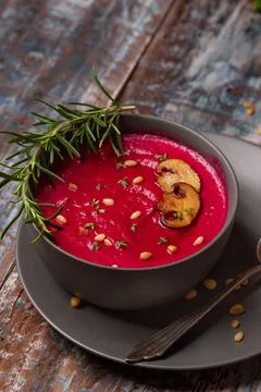 Close up of a beetroot soup. Served with pine nuts and muschrooms. Stock Photos