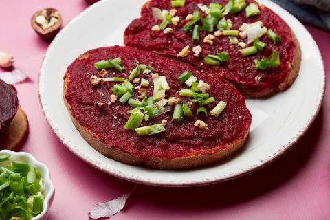 Close up of beetroot spread sandwiches with spring young onion, garlic and Stock Photos