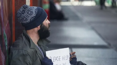 Close up on beggar sad and desperate in the street that is ignored by people Stock Footage 74692953