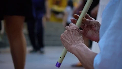 Close-up of a beggar's hands, playing the flute Stock Footage