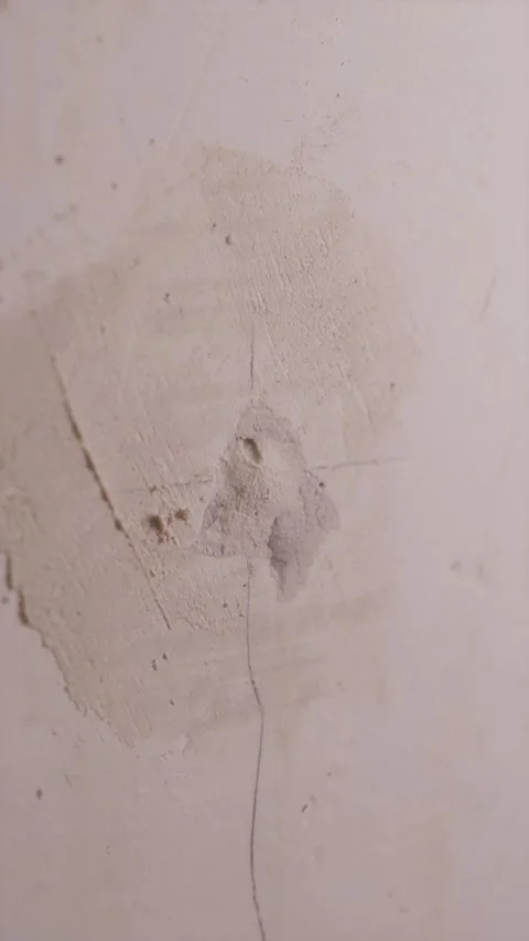 Close up of beginner patching hole in drywall wall Stock Footage 340610533