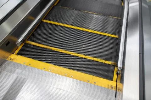 Close-up of the beginning of the escalator. Yellow restrictive notches on the Stock Photos