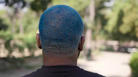 Close-up from behind of head of black man with blue curly short hair 스톡 동영상 287488136