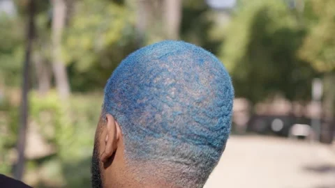 Close-up from behind of head of black man with blue curly short hair 스톡 동영상 287488200