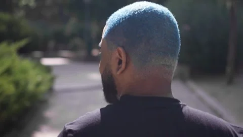 Close-up from behind of head of black man with blue curly short hair Stock Footage 287488201