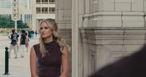 Close-up from behind of a man standing opposite a beautiful blonde woman on a 스톡 동영상 347012435