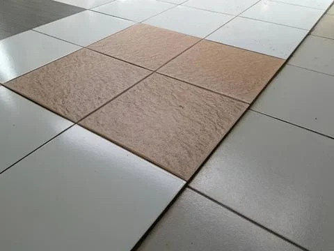 Close-up of beige and gray tiled floor with pattern 스톡 사진