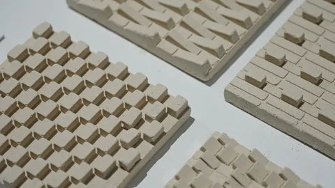 Close-up of beige ceramic relief tiles with repeating geometric textures Stock Footage 327530599