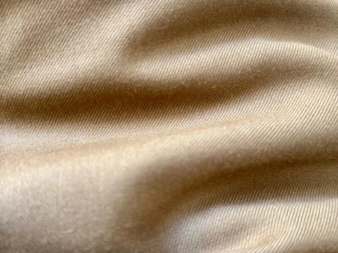 Close-up of beige fabric with visible texture and folds Stock Photos