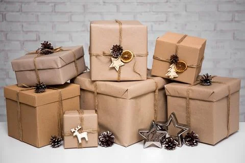 Close up of beige gift boxes over white brick wall Stockfoto's