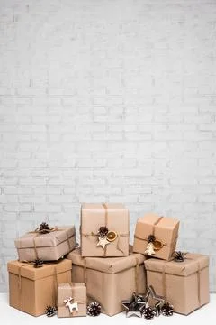 Close up of beige gift boxes over white brick wall with copy space 写真素材