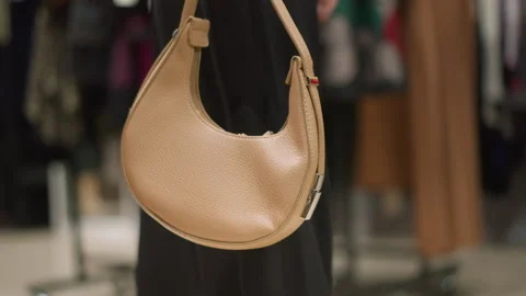 Close up of beige leather handbag with smooth texture and metal hardware in Stock Footage 346730895