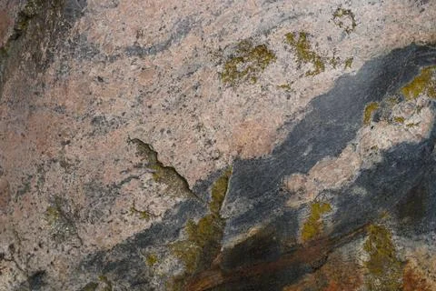 Close-up of beige-pink cobblestone texture with gray veins and greenish cracks Stock Photos
