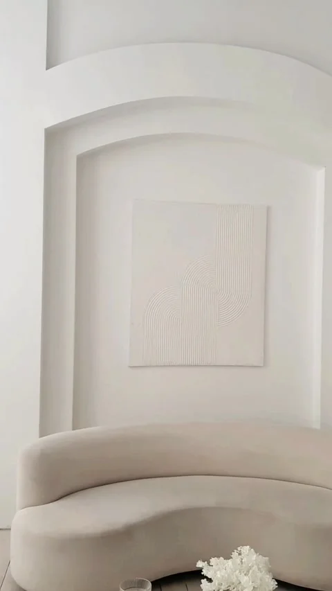 Close-up beige sofa with soft smooth upholstery fabric stands against a light wa Stock Footage 303925072