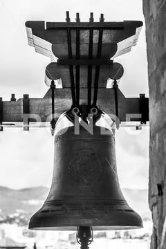 Close-up of a bell and cityscape in the background Stock Photos