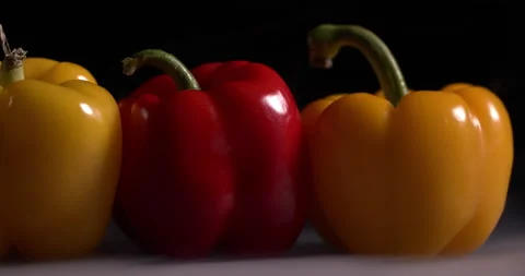 Close up bell pepper lies on a table on a black background Stock Footage 130537055