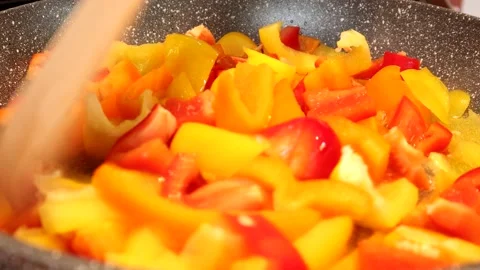 Close-up Of Bell Peppers Being Fried And Stirred With a Wooden Spatula 스톡 동영상 138043610