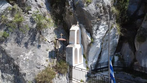 Close-up of bell tower and chapel entrance on a cliff in the Greek islands Stock Footage 343932459