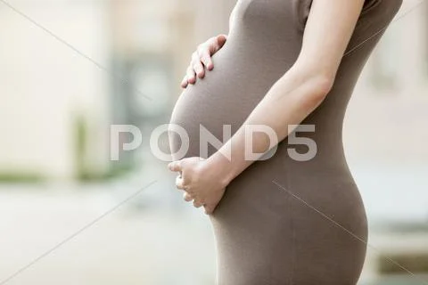 Close-Up Of Belly Of Pregnant Woman Office Worker