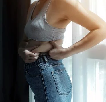 Close up of a belly with scar from c-section and abdominal fat. Women's hea.. Foto stock