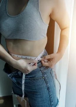 Close up of a belly with scar from c-section and abdominal fat. Women's hea.. Stock Photos