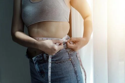Close up of a belly with scar from c-section and abdominal fat. Women's hea.. Stock Photos