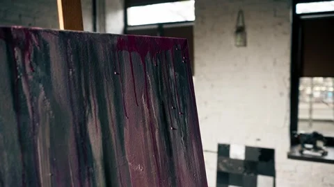 Close-up from below in art workshop the artist makes pink streaks on canvas Stock Footage 275504619