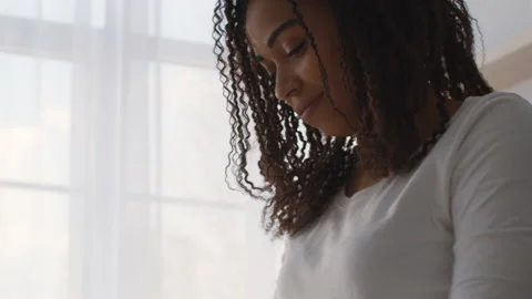 Close up below portrait of focused african american woman doing something at Stock Footage 156223267
