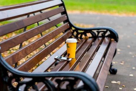 Close up of a bench in the spring or fall, is  cup  tea  coffee, breakfast i Stock Photos