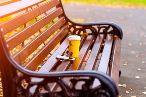 Close up of a bench in the spring or fall, is  cup  tea  coffee, breakfast i Stock Photos
